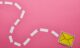 top view of yellow sending delivering email sign on pink background